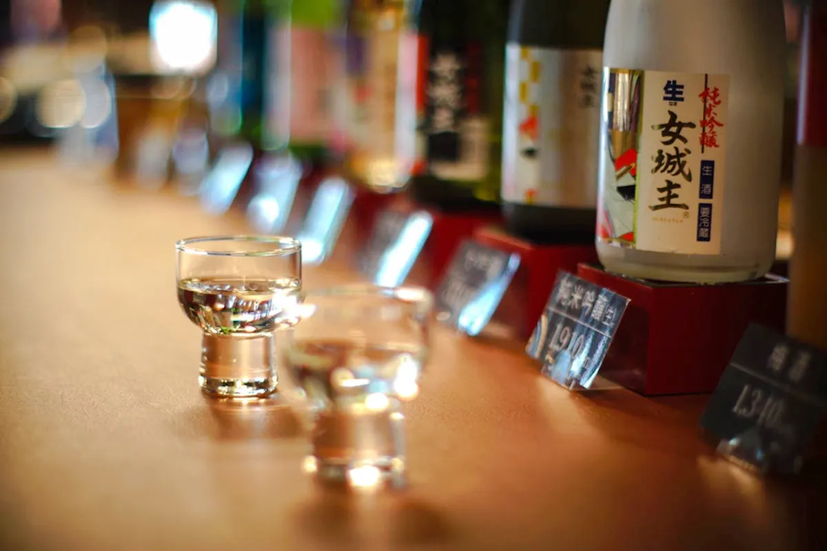 Sake glasses and bottles at Iwamura Brewery during night tour, Gifu.