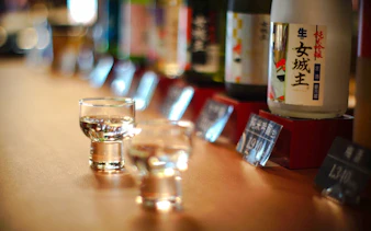 Sake glasses and bottles at Iwamura Brewery during night tour, Gifu.