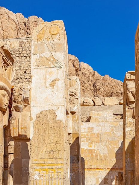 Hathor capital columns at Mortuary Temple of Hatshepsut, Luxor, Egypt, with hieroglyphs.