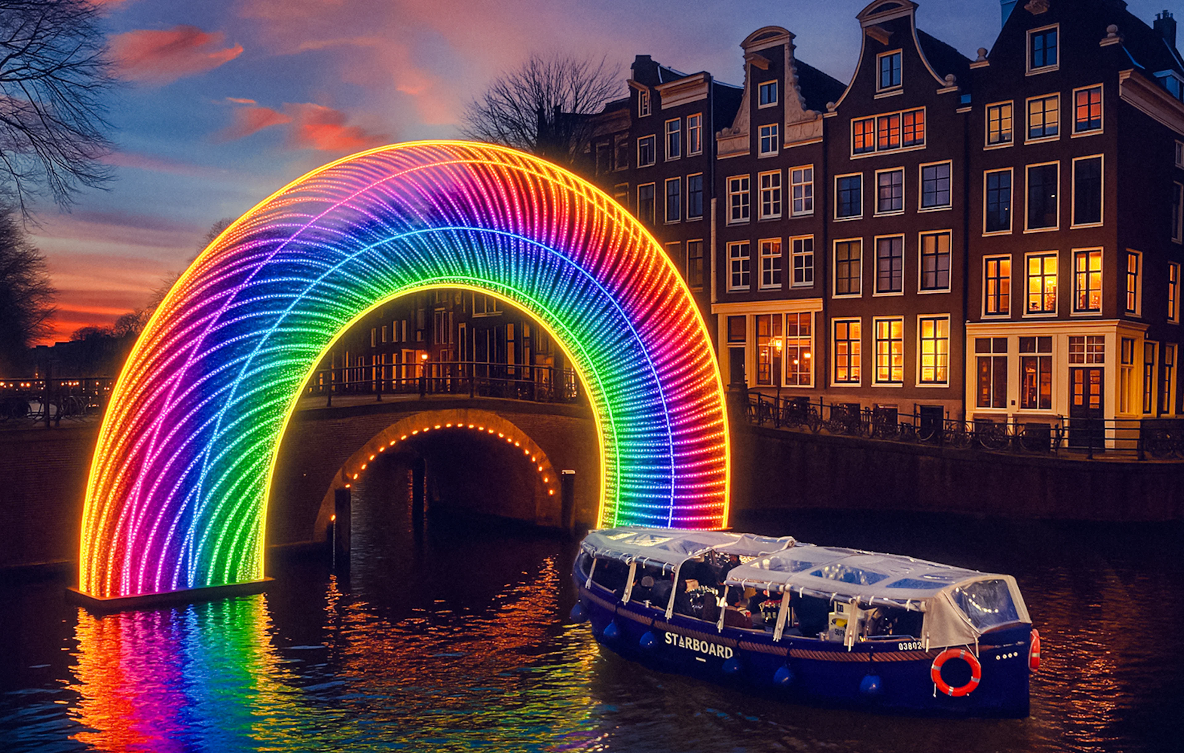 Amsterdam canal cruise passing under illuminated rainbow arch during Light Festival.