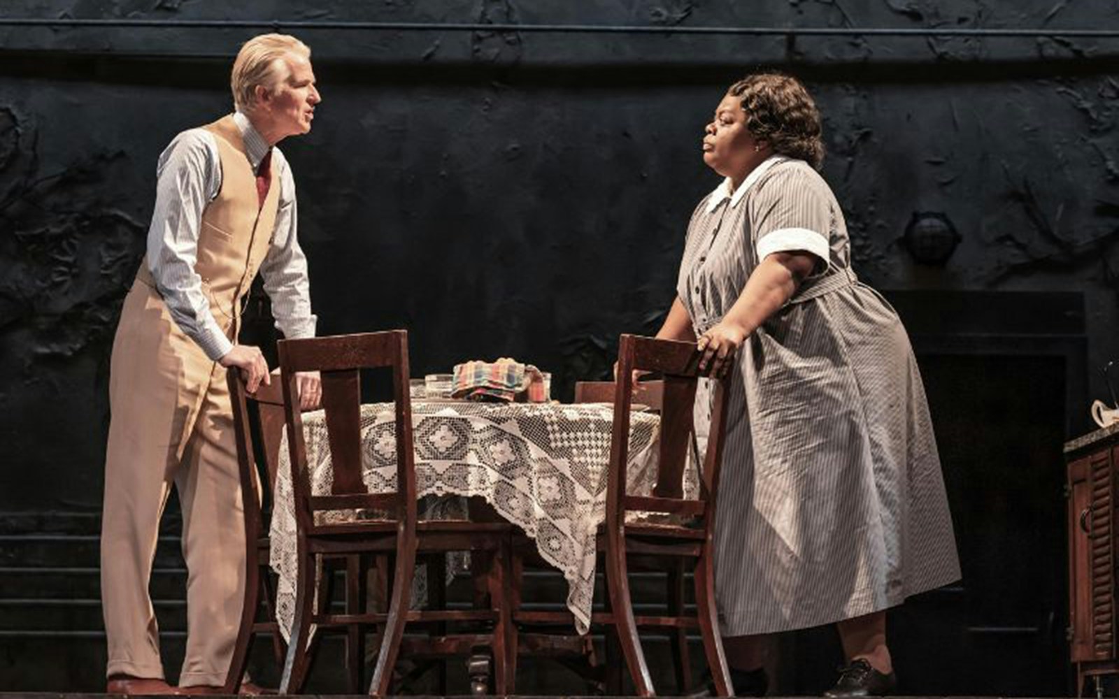Actors performing a scene from "To Kill A Mockingbird" on stage.