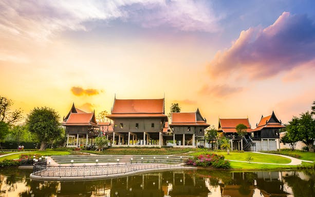 Traditional architecture in Mallika City, 1905 A.D., reflecting cultural heritage at sunset.