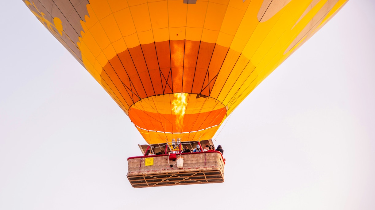 VIP hot air balloon with passengers ascending over Marrakech.