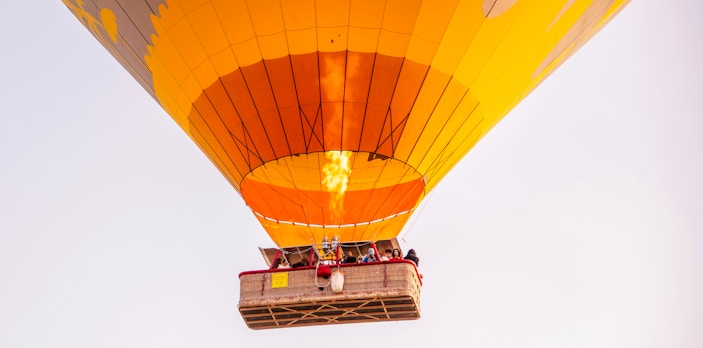 VIP hot air balloon with passengers ascending over Marrakech.