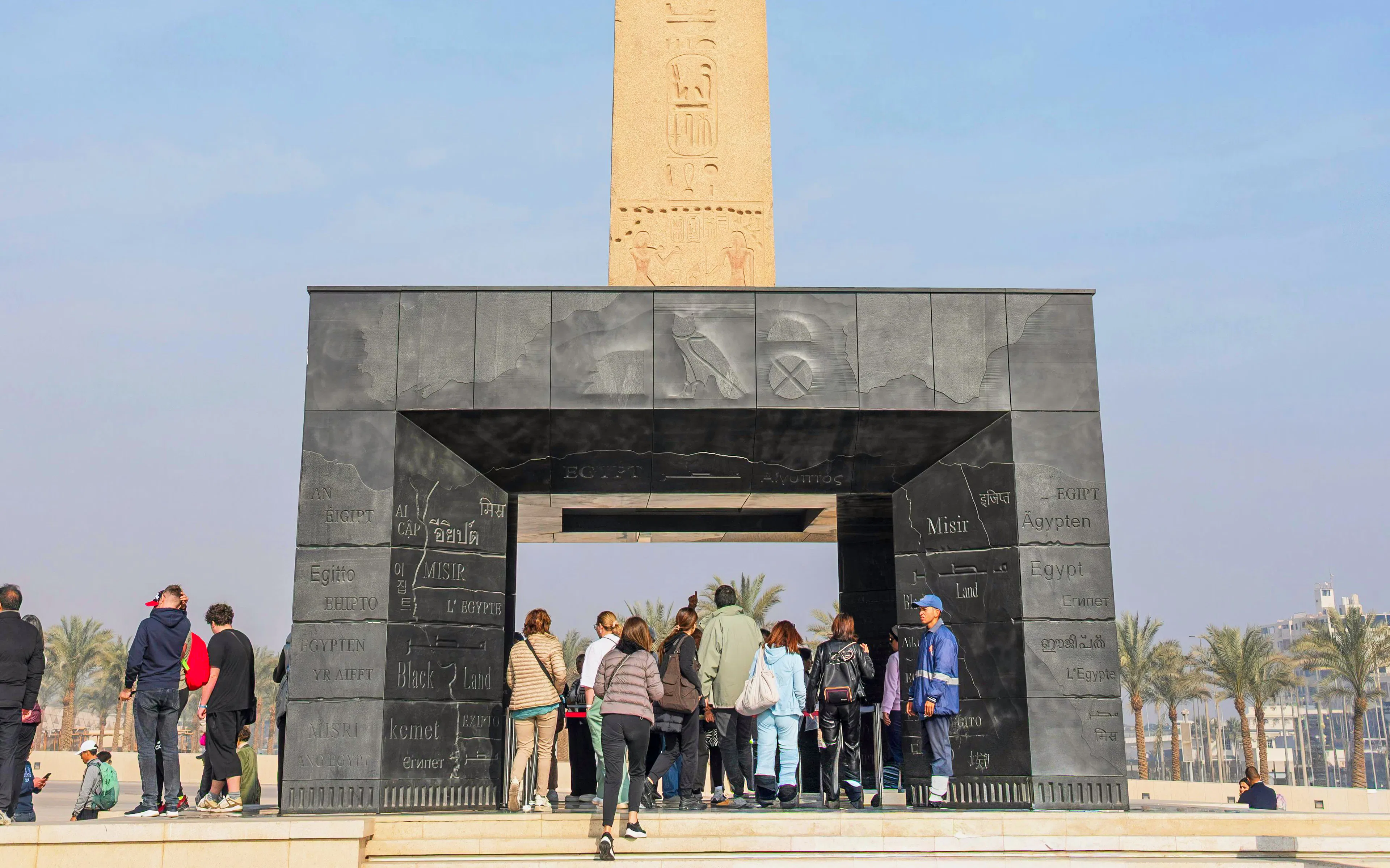 Visitors at the Grand Egyptian Museum's Hanging Obelisk entrance, Cairo, Egypt.