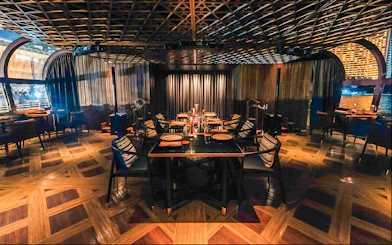Dining area on Saffron Luxury Cruise by Banyan Tree with elegant table settings.
