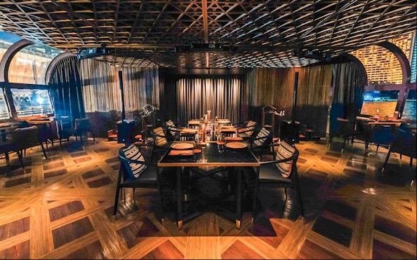 Dining area on Saffron Luxury Cruise by Banyan Tree with elegant table settings.