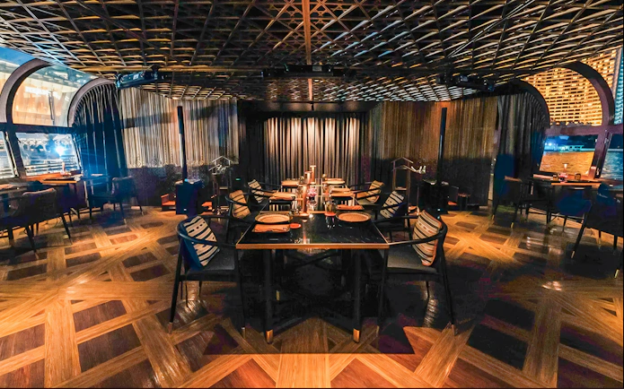 Dining area on Saffron Luxury Cruise by Banyan Tree with elegant table settings.
