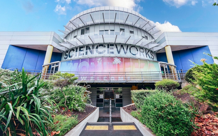 Exterior of Scienceworks museum with colorful entrance signage during daytime.