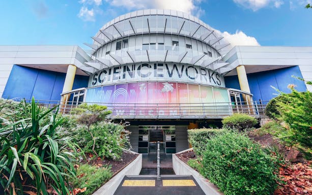 Exterior of Scienceworks museum with colorful entrance signage during daytime.