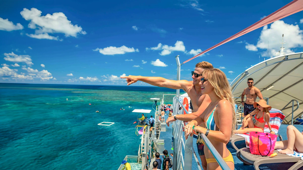 Tourists on pontoon enjoying Moore Reef views, Great Barrier Reef.