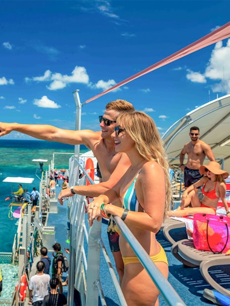Tourists on pontoon enjoying Moore Reef views, Great Barrier Reef.