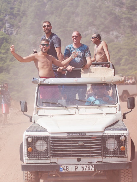 Jeep with tourists on a dusty trail during Antalya safari tour.