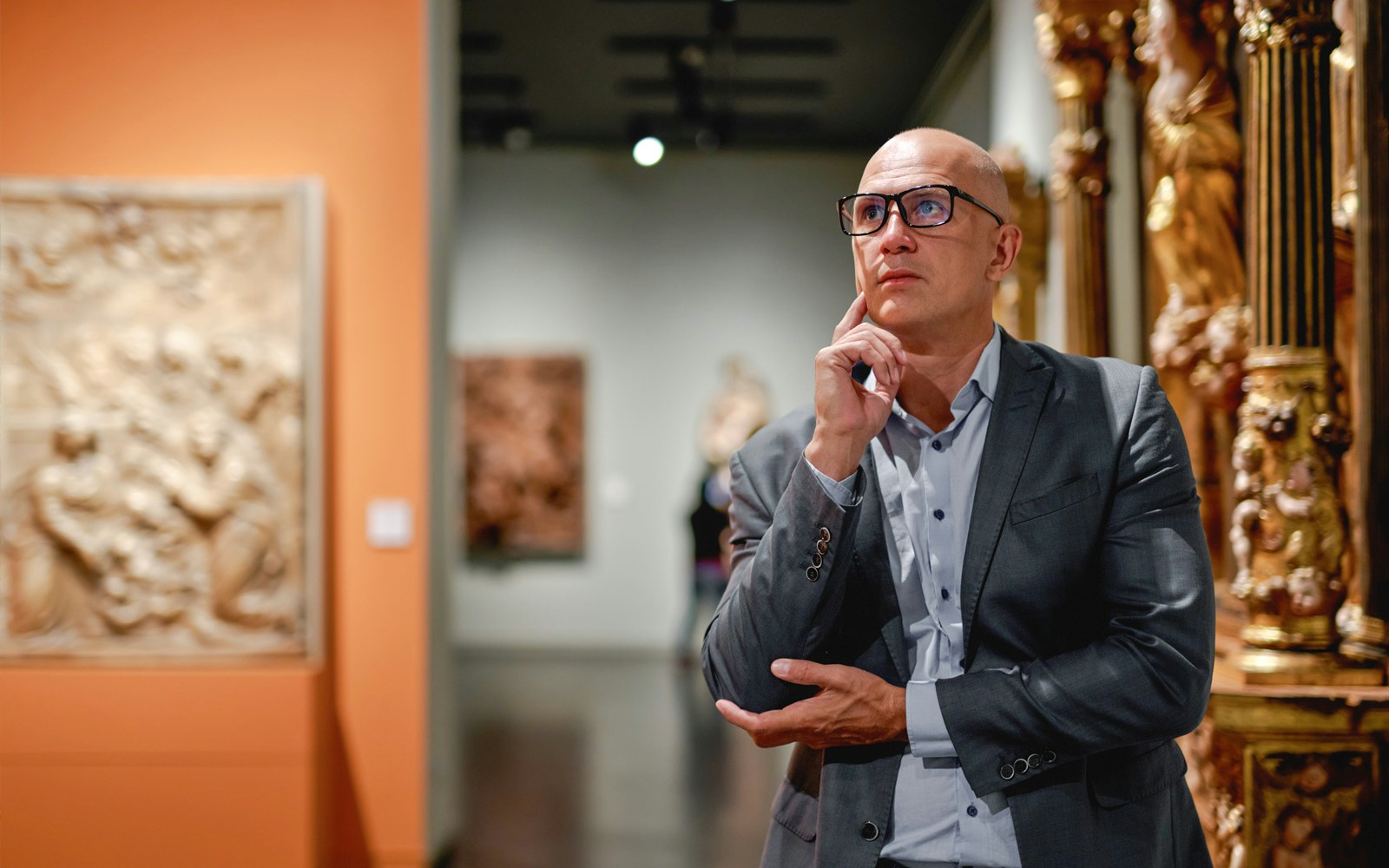 Man observing artwork in an art gallery.