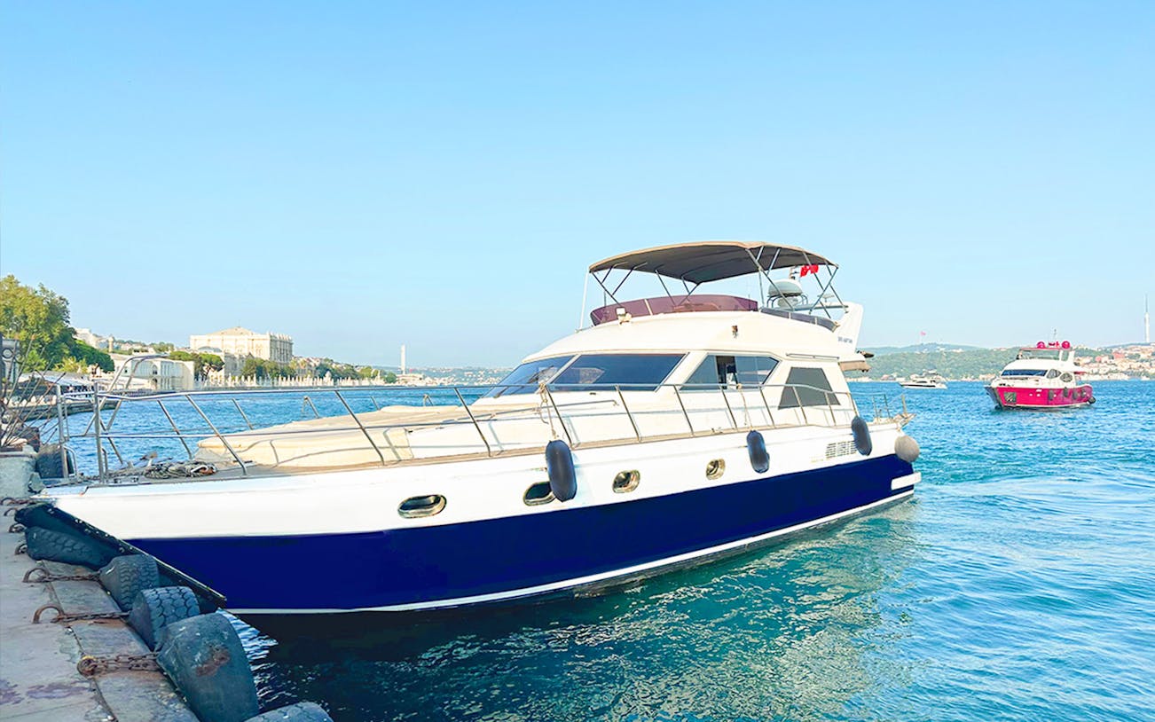 Yacht docked on the Bosphorus with cityscape in the background, Istanbul.