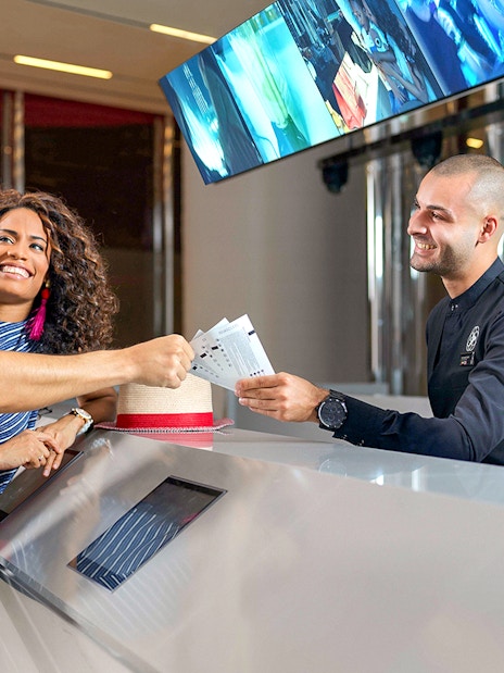 Visitors receiving tickets for Burj Khalifa's SKY level observation deck in Dubai.
