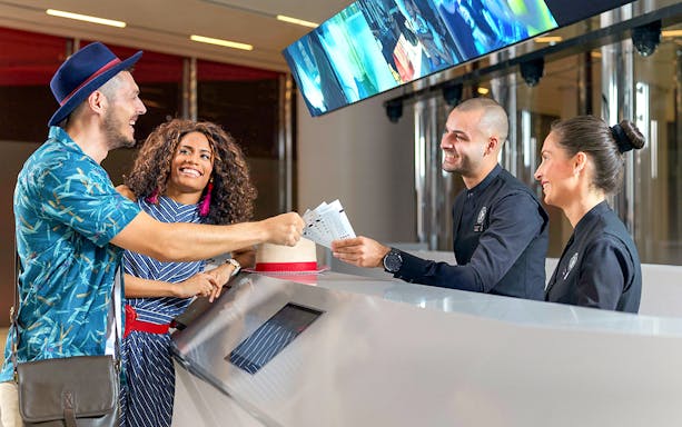 Visitors receiving tickets for Burj Khalifa's SKY level observation deck in Dubai.