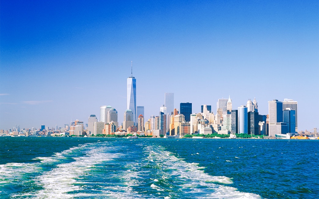 Manhattan skyline from the water on a sunny day.