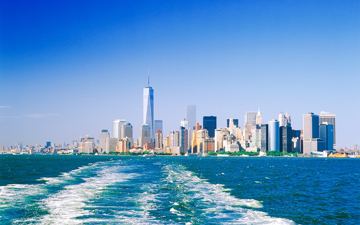 Manhattan skyline from the water on a sunny day.