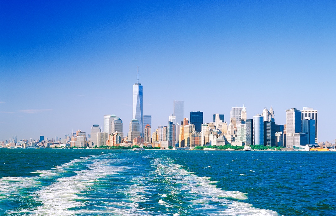 Manhattan skyline from the water on a sunny day.