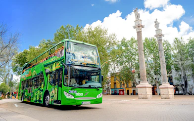Hop on hop off tour bus near La Alameda columns, Seville.