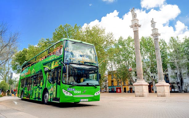 Hop on hop off tour bus near La Alameda columns, Seville.