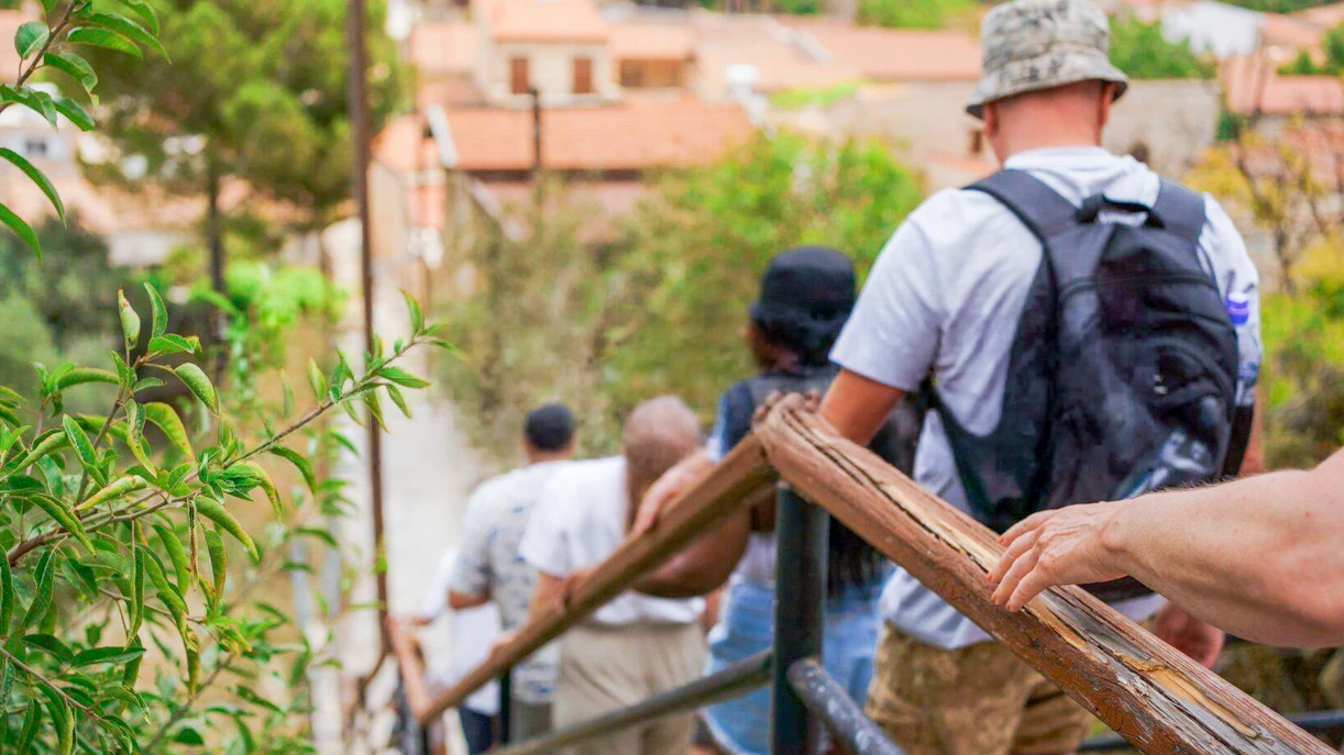 Tourists walking down a path in a Troodos Mountains village near Paphos.