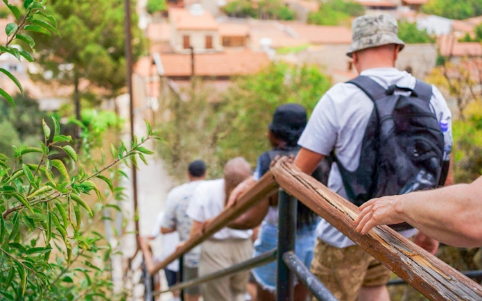 Tourists walking down a path in a Troodos Mountains village near Paphos.