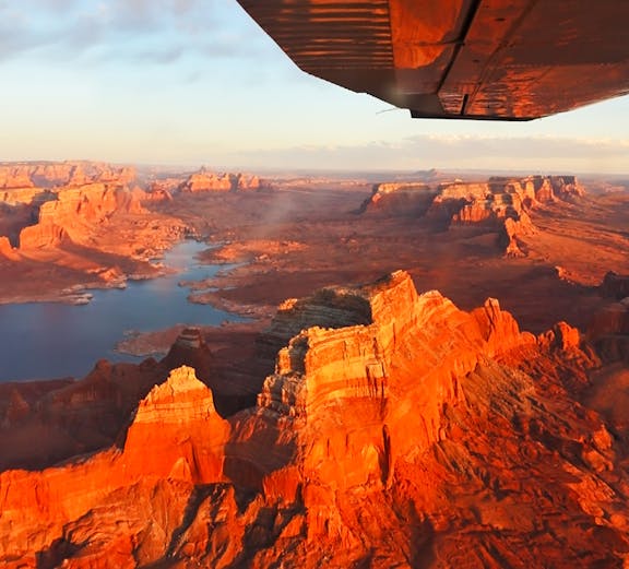 Aerial view of Antelope Canyon's red rock formations and river from an airplane.