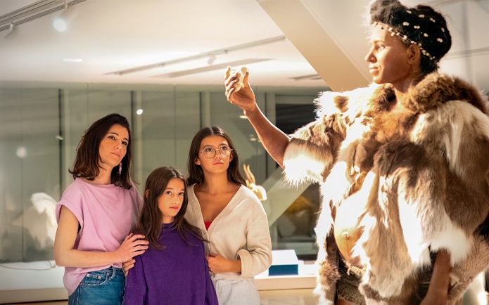Visitors observing a prehistoric exhibit at Cosquer Cave, Marseille.