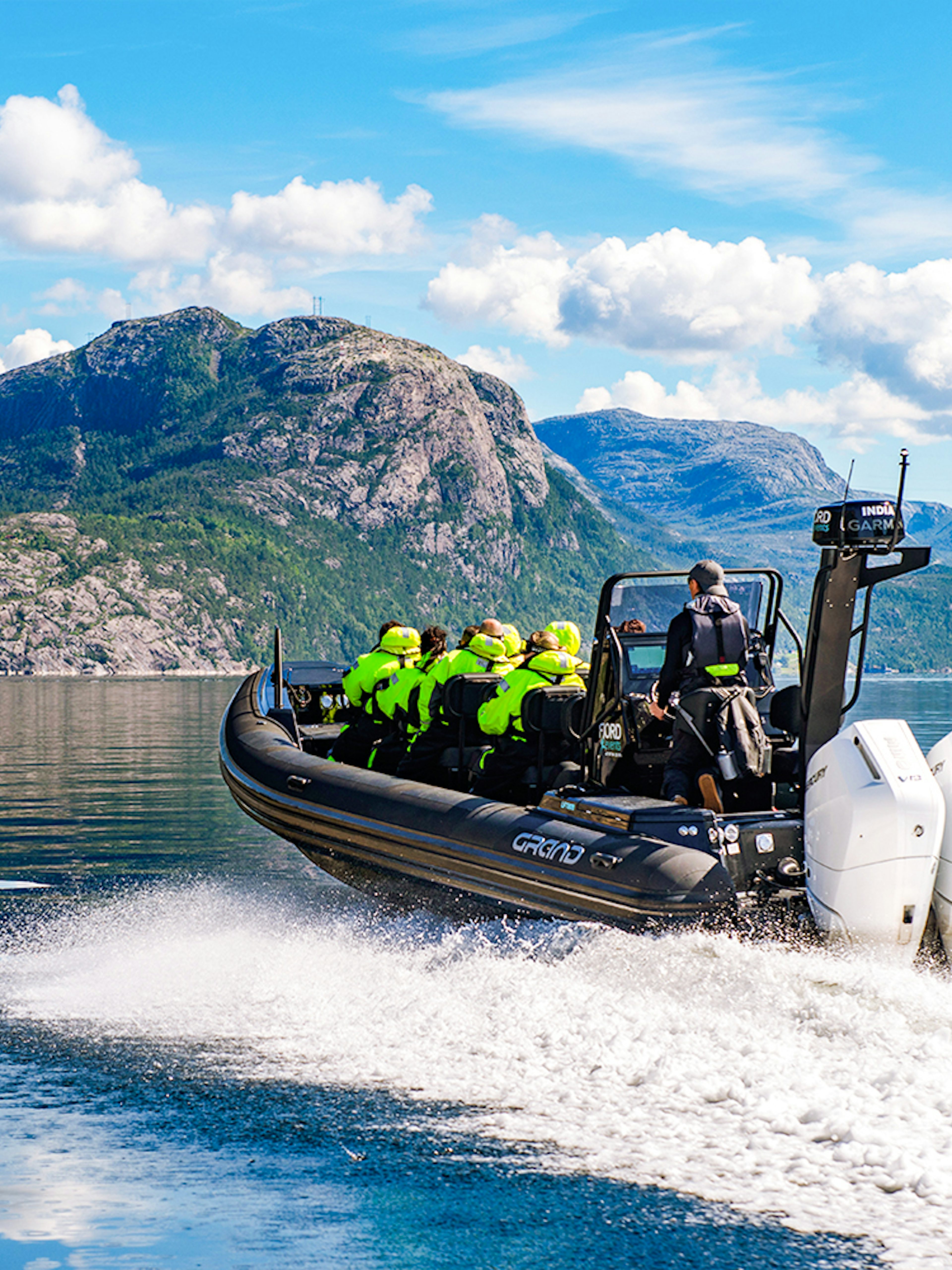 Guests on a RIB boat during Lysefjord Safari, Norway, with scenic mountain views.