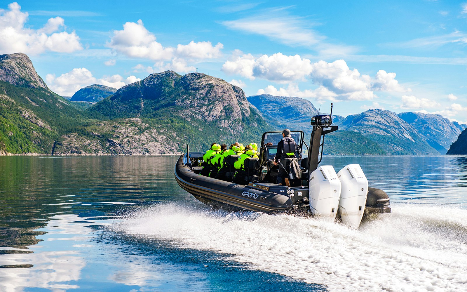 Guests on a RIB boat during Lysefjord Safari, Norway, with scenic mountain views.