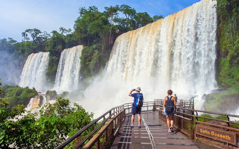 Tourists walking on a platform near Salto Bossetti at Iguazu Falls.