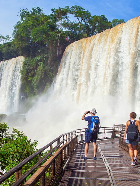 Tourists walking on a platform near Salto Bossetti at Iguazu Falls.