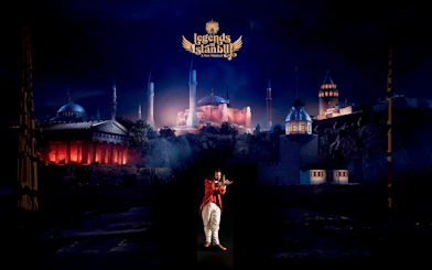Performer on stage at Legends of Istanbul with cityscape backdrop.
