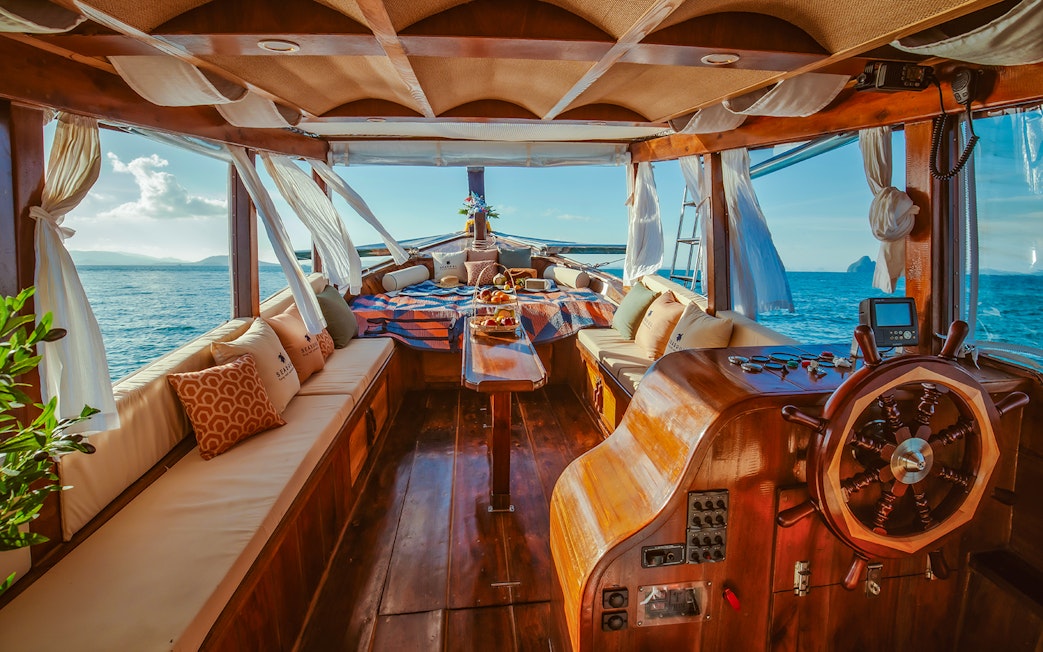 Luxury longtail boat interior with fruits and drinks, Krabi sunset cruise.