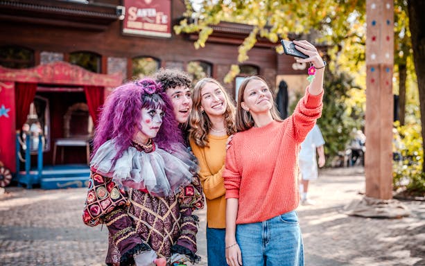 Group taking a selfie with a Halloween performer at Bobbejaanland.