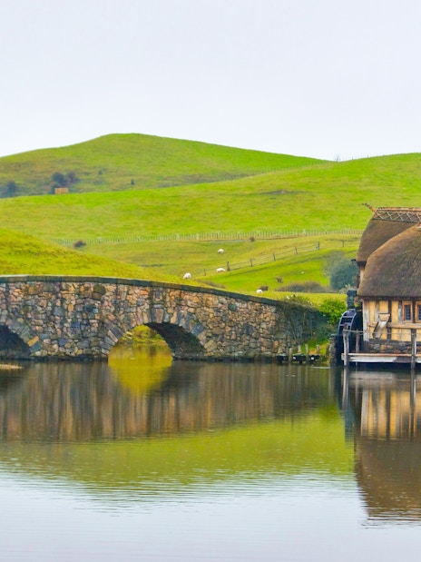 Double arched stone bridge and mill at Hobbiton Movie Set, Matamata, New Zealand.