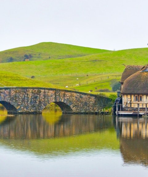 Double arched stone bridge and mill at Hobbiton Movie Set, Matamata, New Zealand.