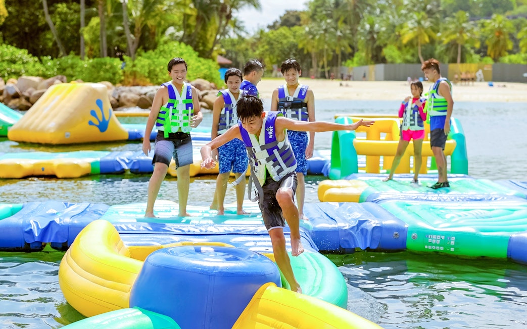Participants enjoying inflatable obstacle course at HydroDash Singapore.