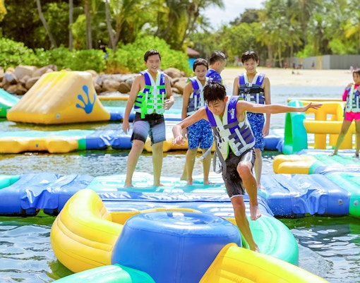 Participants enjoying inflatable obstacle course at HydroDash Singapore.