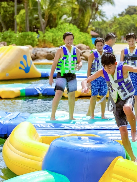 Participants enjoying inflatable obstacle course at HydroDash Singapore.