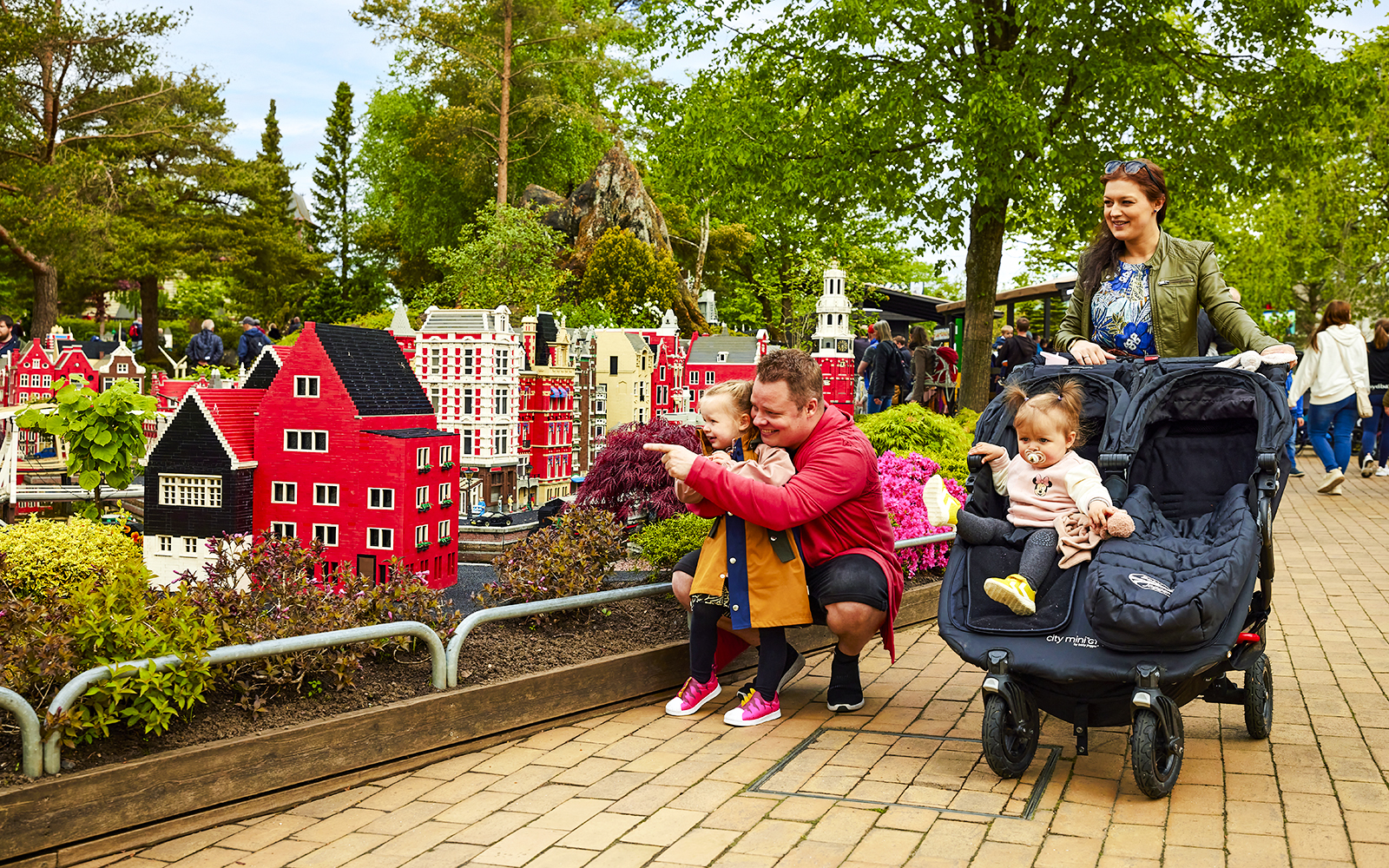 Family exploring LEGO models at LEGOLAND Billund.