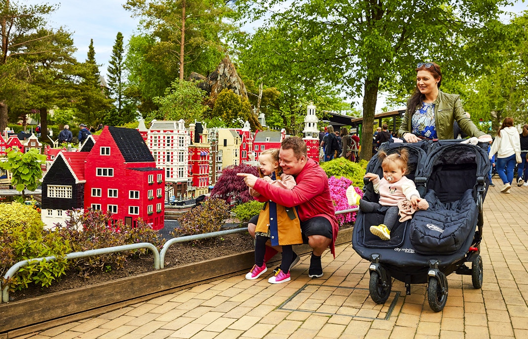 Family exploring LEGO models at LEGOLAND Billund.
