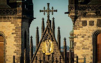Gothic architecture detail on Prague's Charles Bridge during self-guided city exploration game.