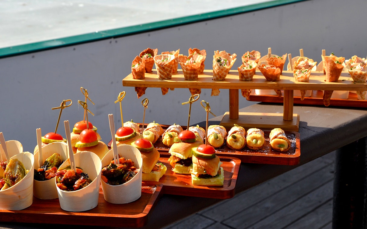 Assorted appetizers displayed at Wollman ICE Rink event in New York City.