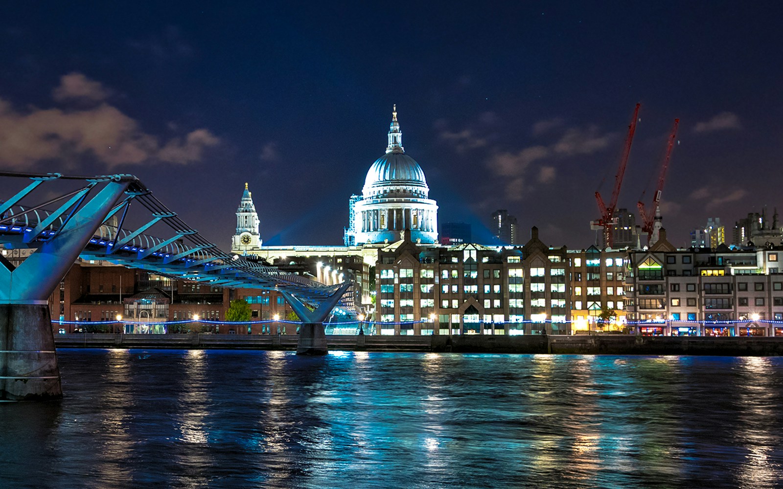 Millennium Bridge and St. Paul's Cathedral illuminated at night, London.