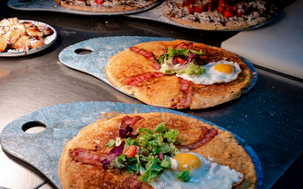 Dutch pancakes with bacon, egg, and salad served during Rembrandt tour brunch in Amsterdam.