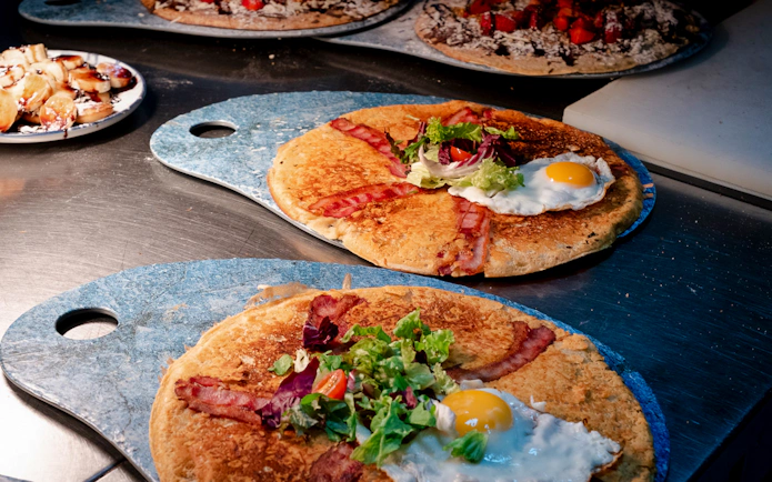 Dutch pancakes with bacon, egg, and salad served during Rembrandt tour brunch in Amsterdam.
