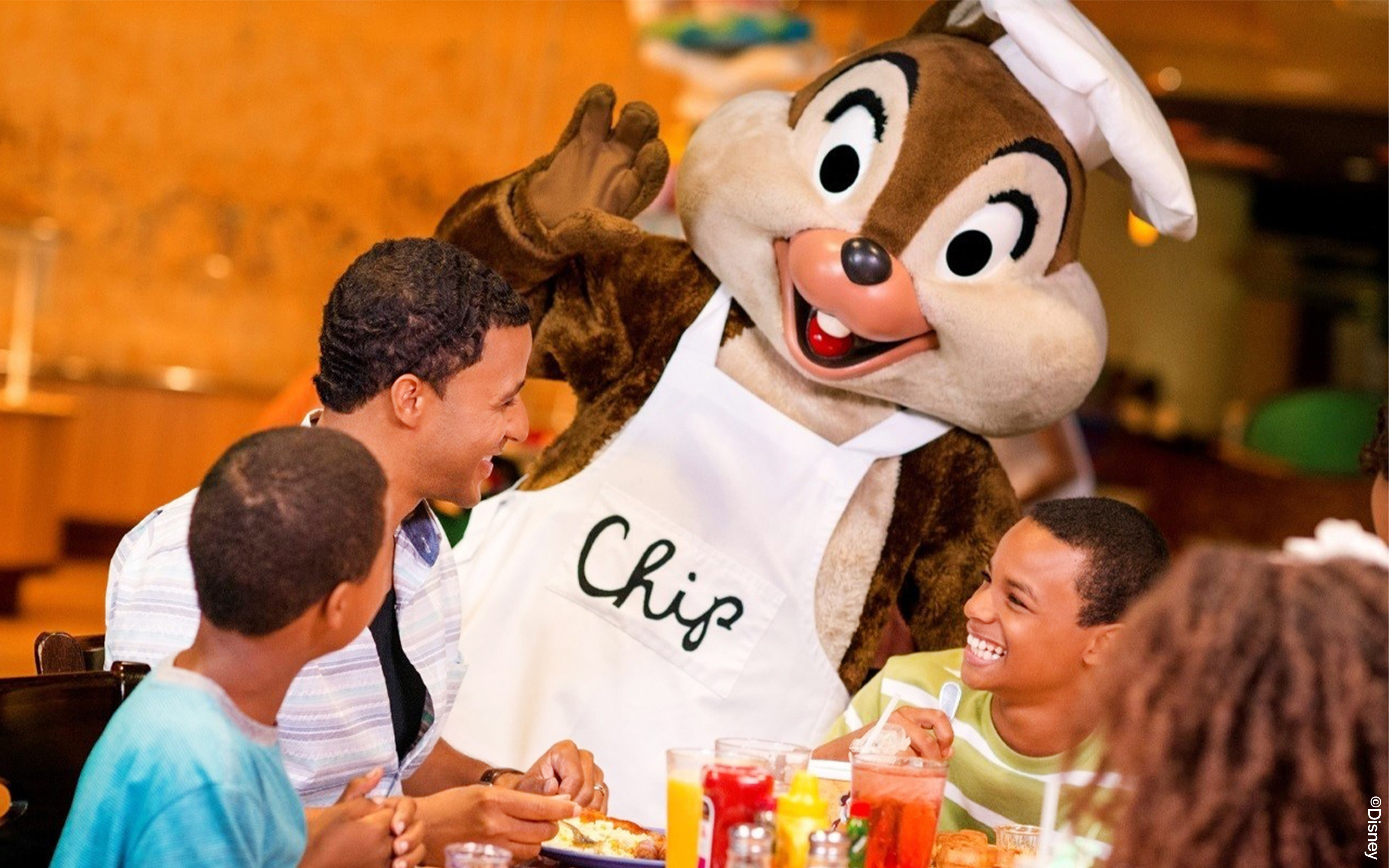 Guests enjoying a meal with a character at Disneyland Park, California restaurant.